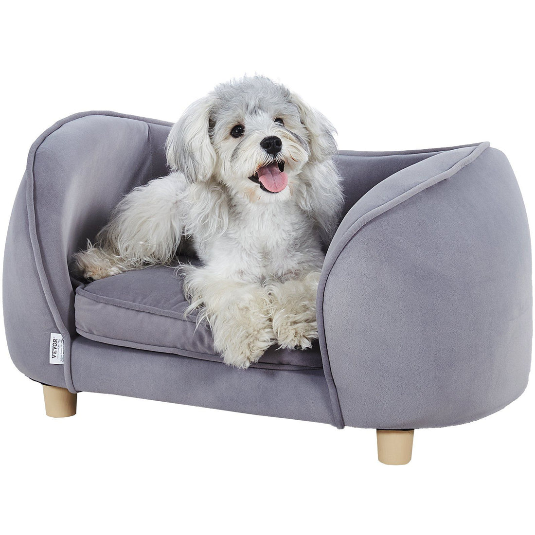 Grey velvet raised-arm pet sofa on wooden legs with a fluffy white dog resting on the cushion