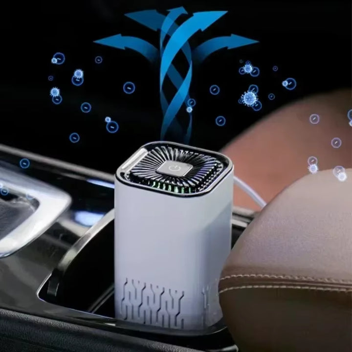 Mini air purifier on a desk next to laptop