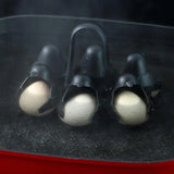 Penguin egg holder cups shown up close with eggs steaming inside a pot