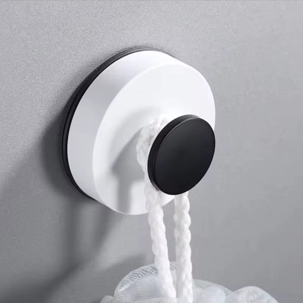 Suction hook holding a mop against a smooth wall