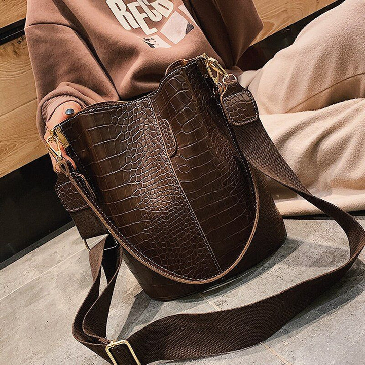 Bucket handbag strap and shoulder carry detail