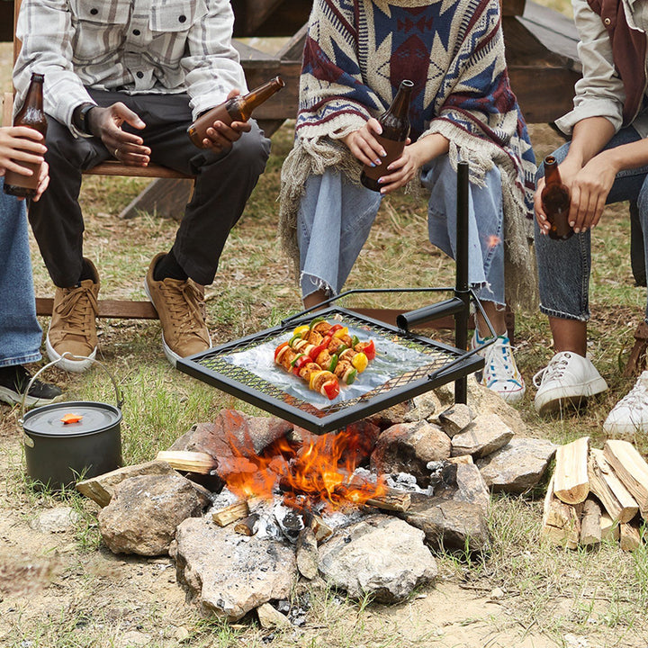 Swivel campfire grill with adjustable steel grate over a fire pit