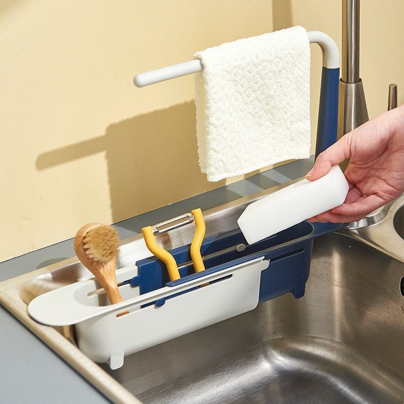 Telescopic sink sponge holder extended across kitchen sink