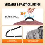 Black velvet hangers holding shirts and dresses