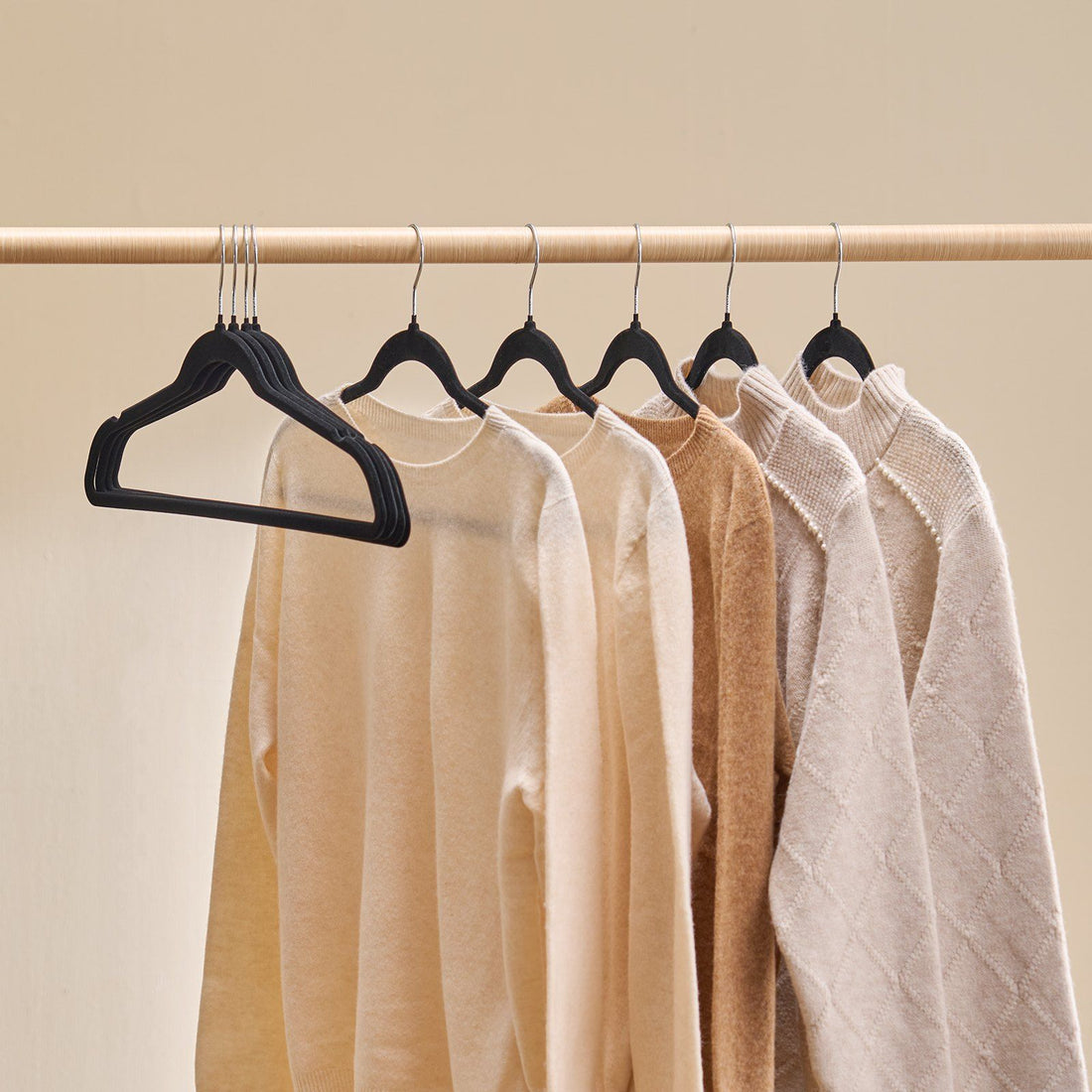 Closet rod filled with matching black velvet hangers
