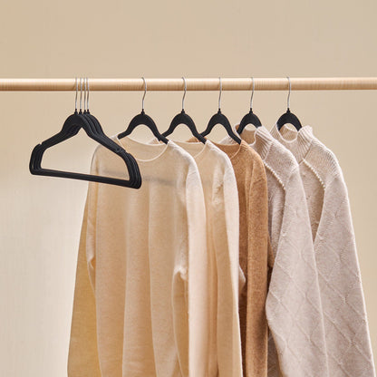Closet rod filled with matching black velvet hangers