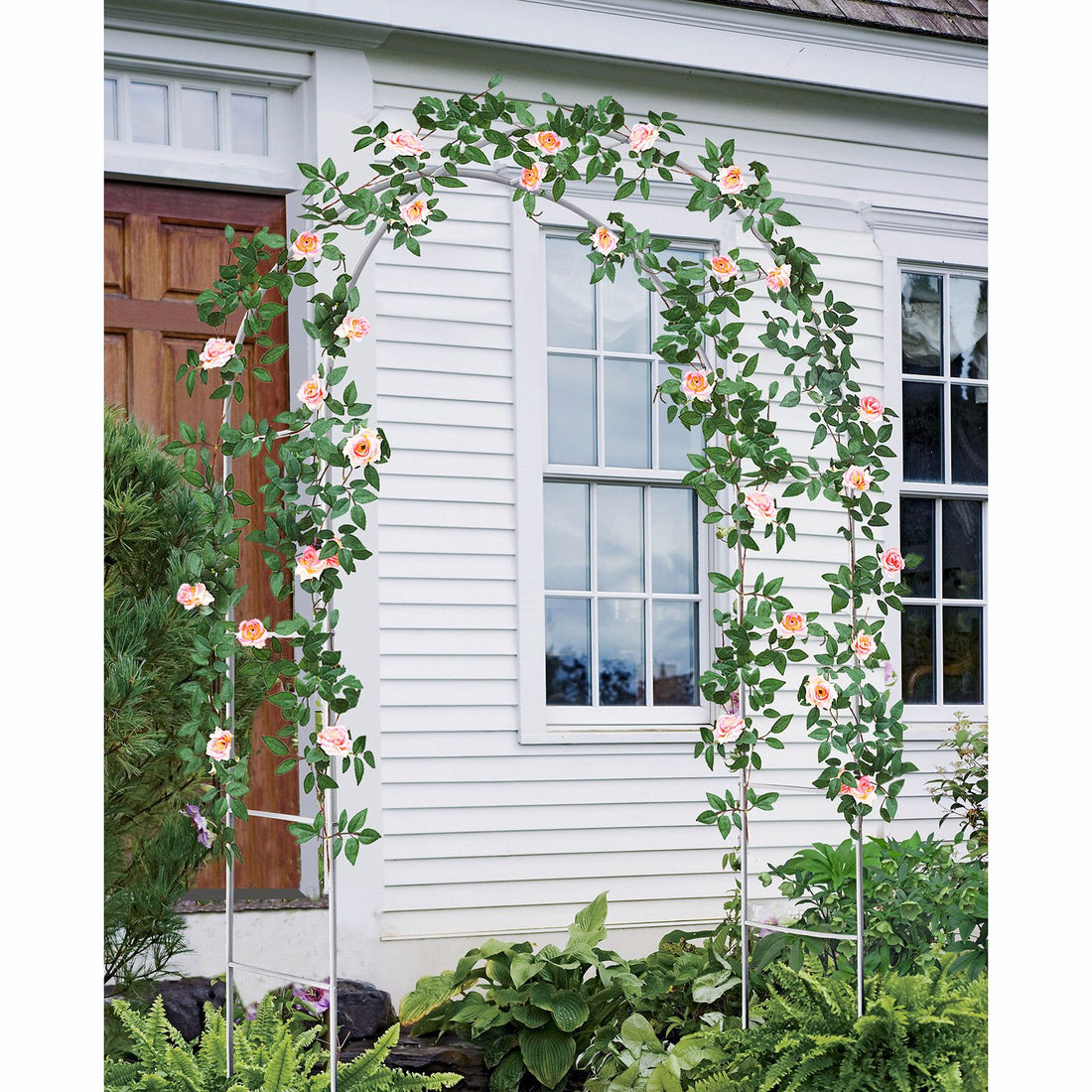White metal garden arch trellis arbor with climbing plants over walkway - alternate angle