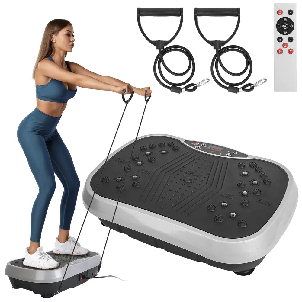Vibration platform with resistance bands and remote control, woman pulling the bands while standing on the platform