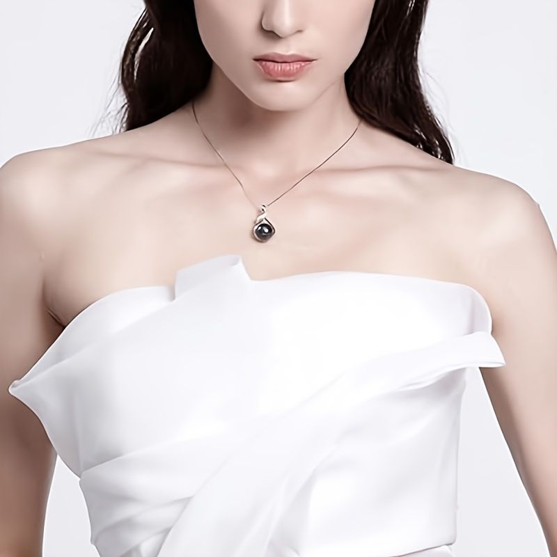 Silver-tone setting detail of Tahitian black pearl necklace