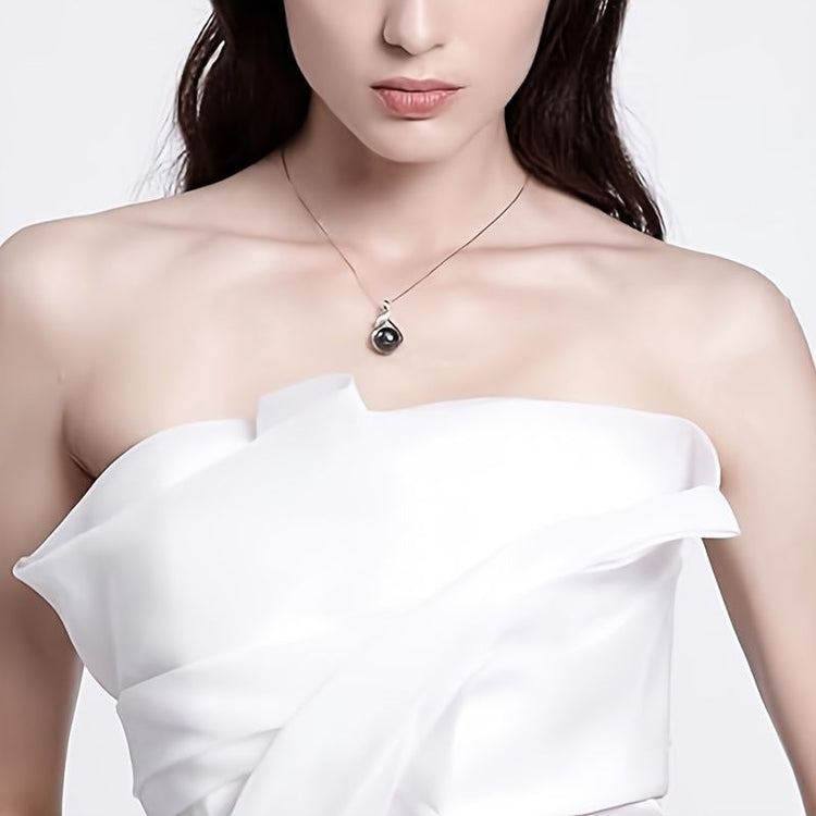 Silver-tone setting detail of Tahitian black pearl necklace