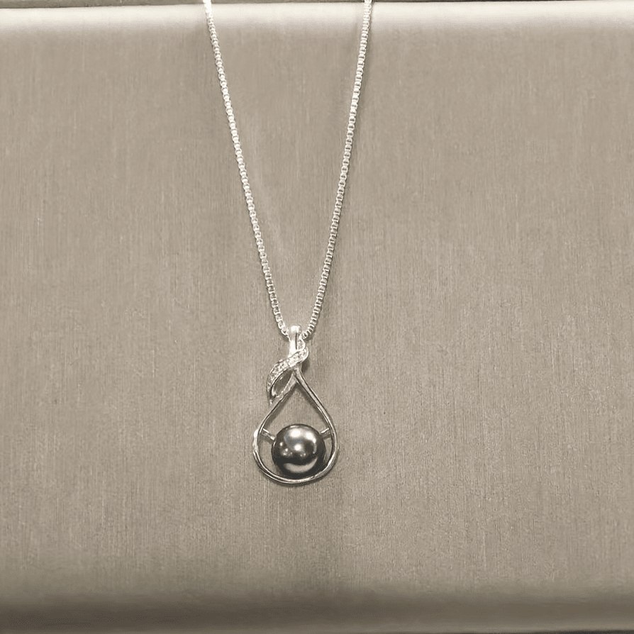 Black pearl necklace worn with neutral top, lifestyle view