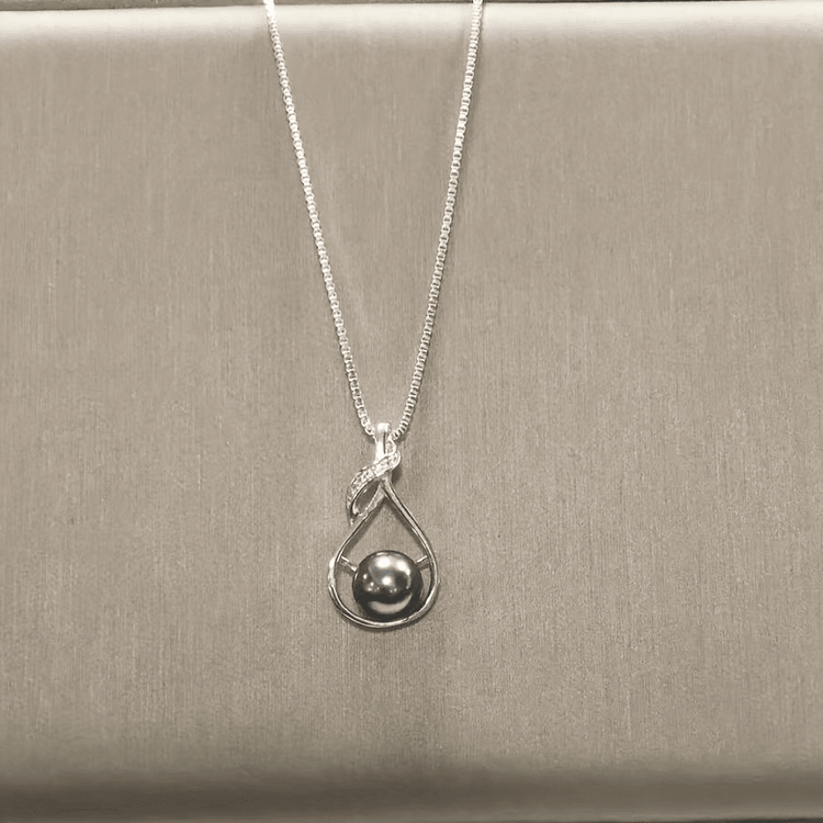 Black pearl necklace worn with neutral top, lifestyle view