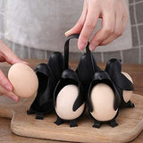 Hand placing an egg into one of the penguin egg holder cups