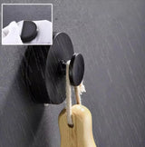 Suction hook holding a hand towel on a glass shower wall