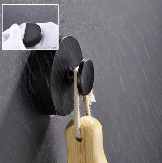 Suction hook holding a hand towel on a glass shower wall