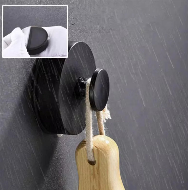 Suction hook holding a hand towel on a glass shower wall