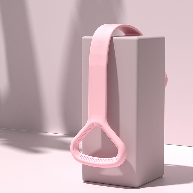 Pink yoga band draped over a display block showing the handle and material