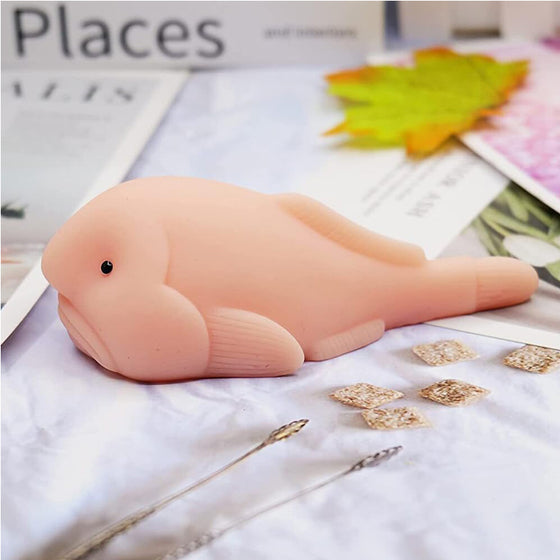 Pink blobfish squishy stress toy lying on a table