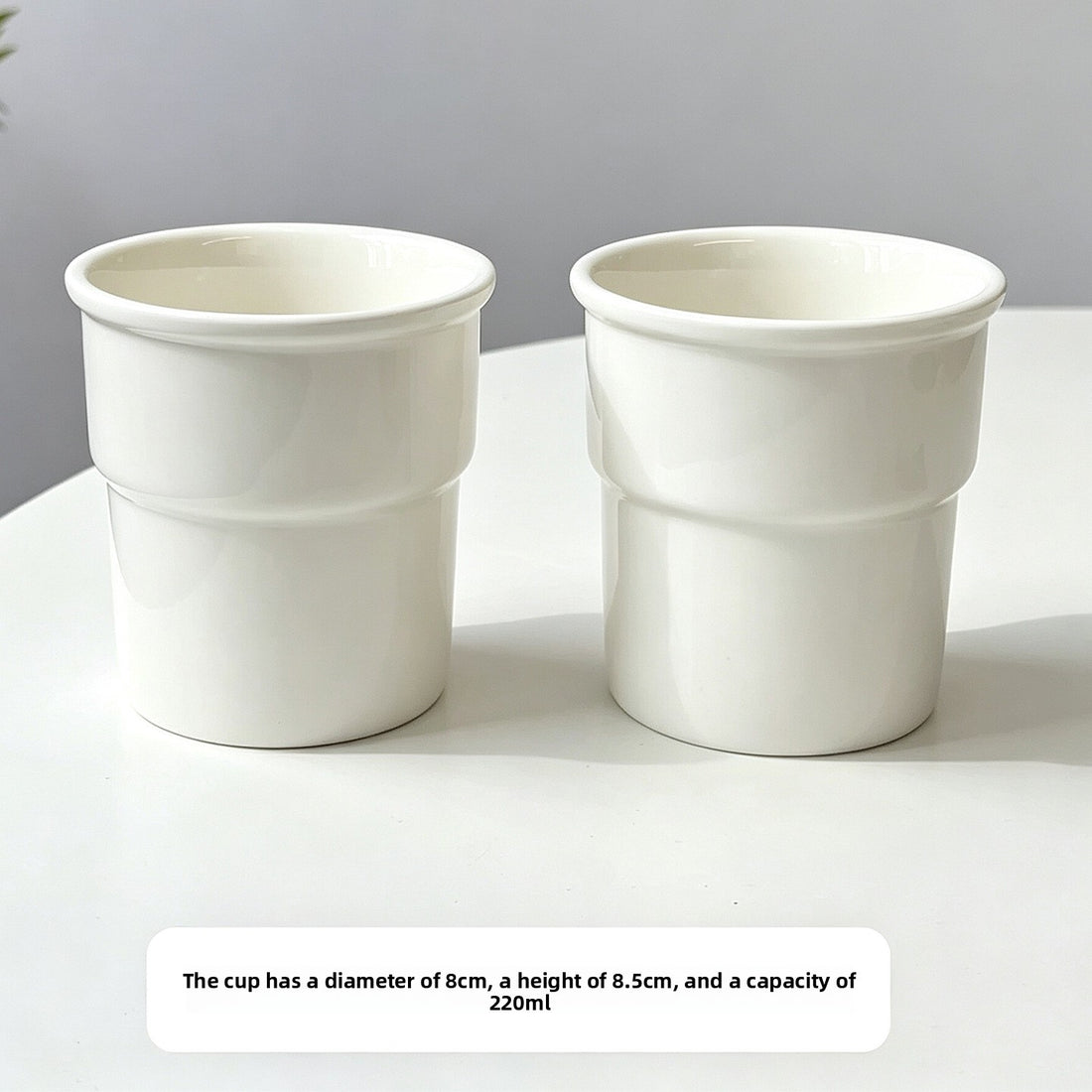 Hand holding a white ceramic cup