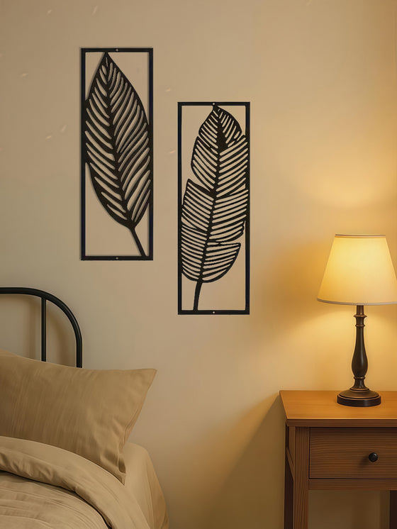 Leaf wall art panels beside a bed and table lamp