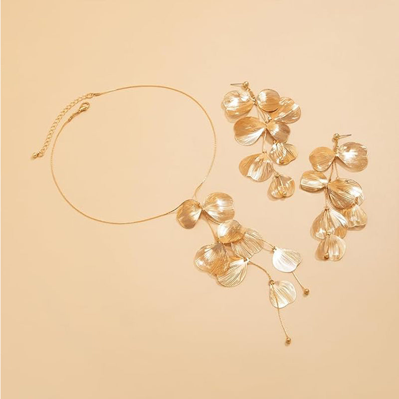 Gold ginkgo leaf tassel choker necklace laid flat on a beige background