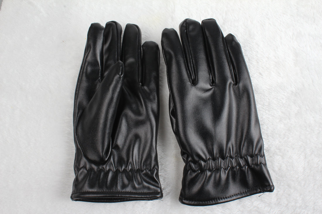 Pair of black PU leather gloves lying flat on a white surface