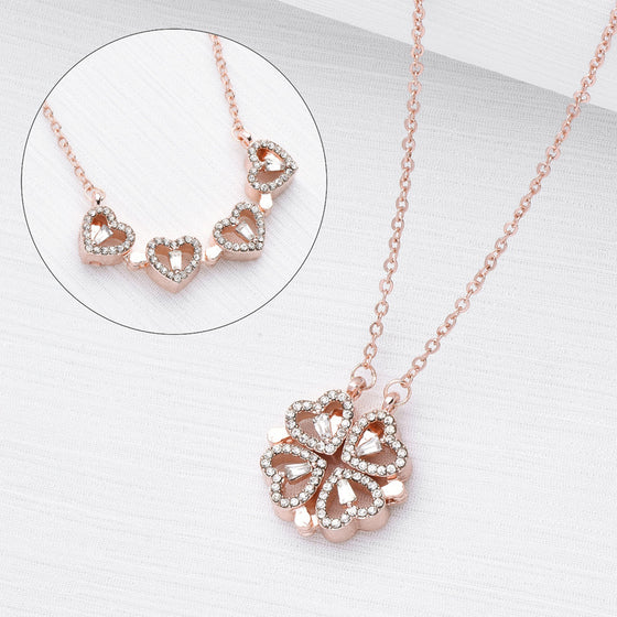 Rose gold-tone clover pendant with an inset of the hearts opened in a row