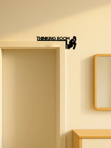 Close-up of matte black cut-metal toilet icon