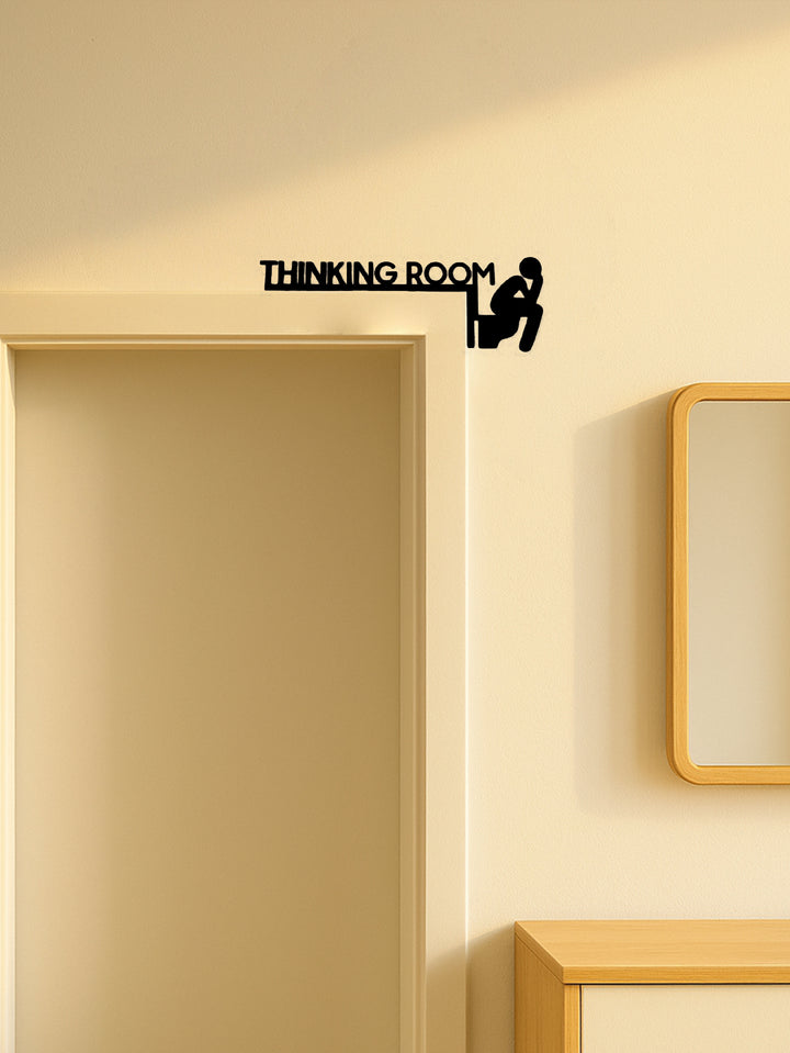 Close-up of matte black cut-metal toilet icon