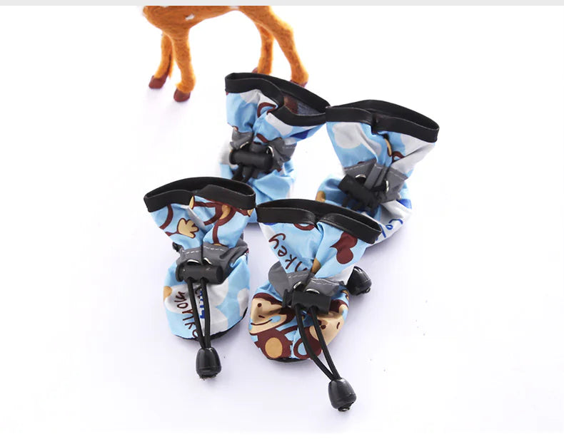 Blue monkey-print dog boots shown as a set of four