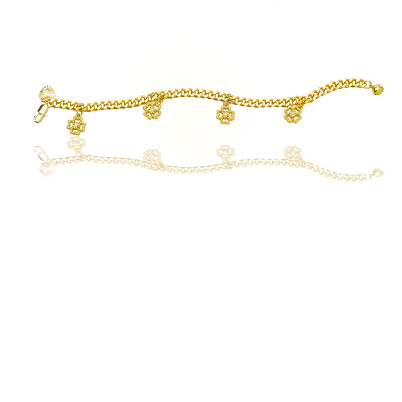 Gold four-leaf clover charm bracelet with reflection on a white background