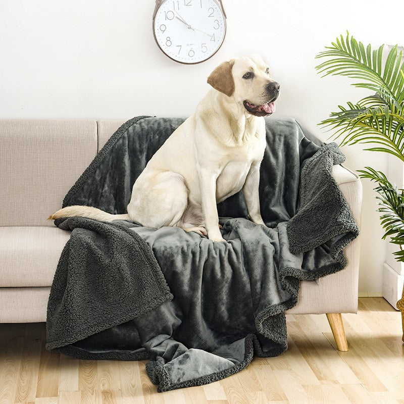 Reversible flannel and sherpa pet blanket on a sofa, photo 1