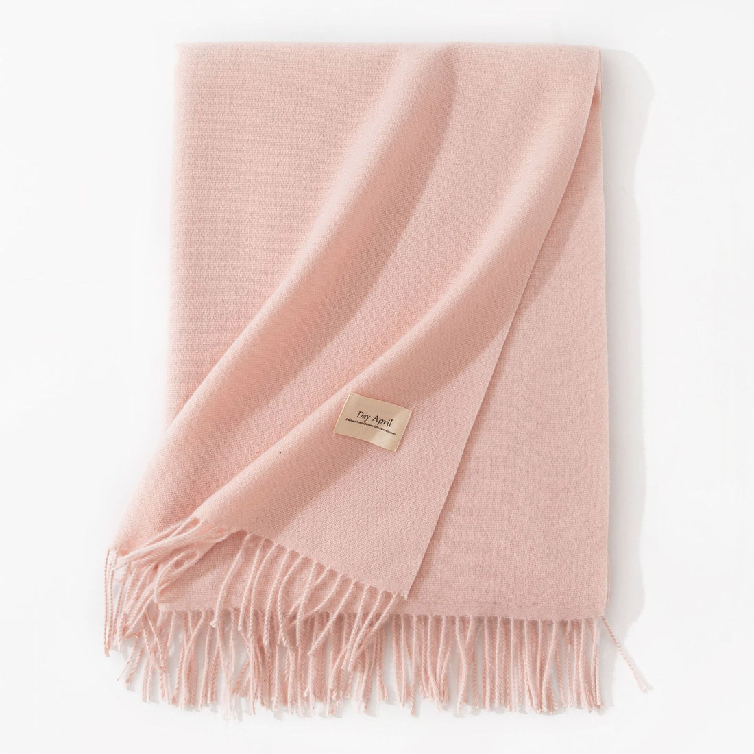 Pale pink faux cashmere scarf with tassels, folded