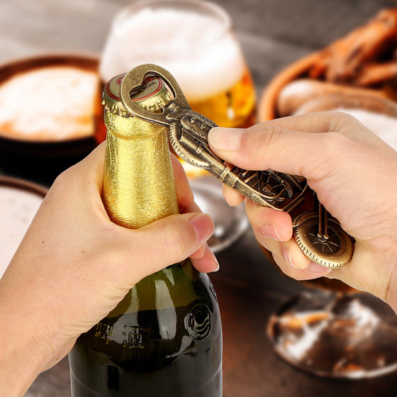 Hand opening a beer bottle with the bronze motorcycle bottle opener