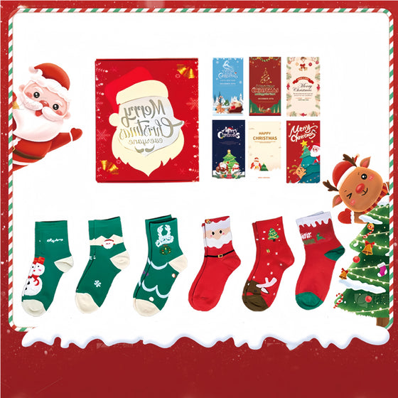 Six pairs of Christmas socks with Santa, snowman and tree designs and six greeting cards