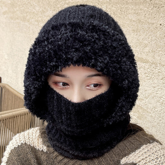 Woman wearing a black knit hood with the neck section over her nose