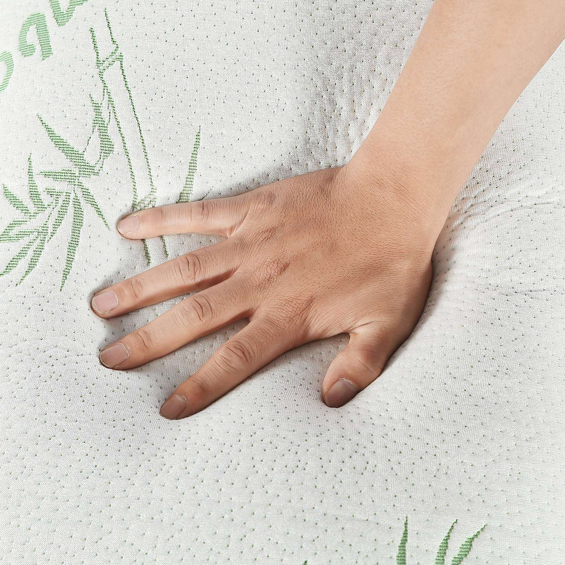 Hand pressing into the quilted pillow cover