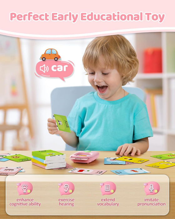 Smiling toddler holding a word card next to the flash card reader