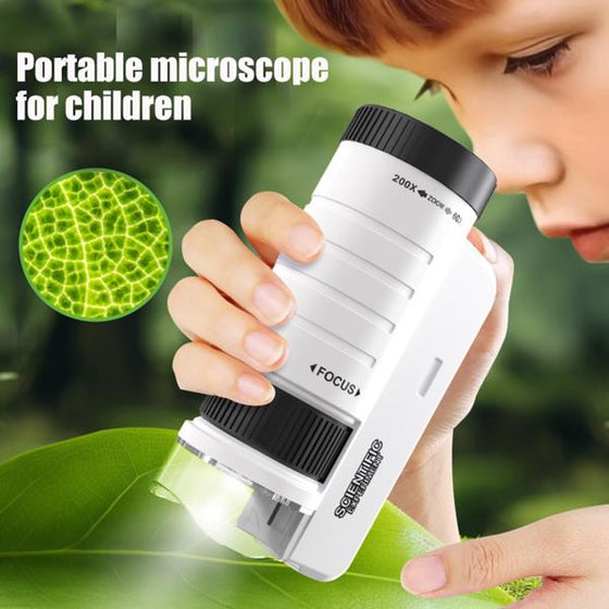 Child looking at a green leaf through a white and black handheld pocket microscope