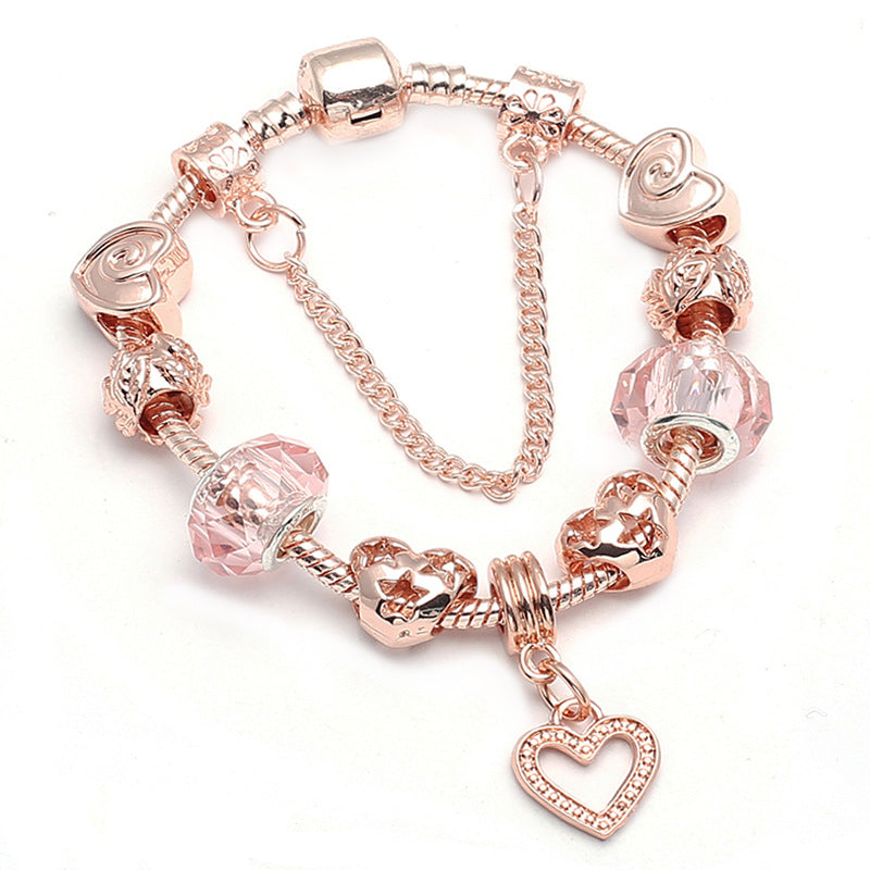 Rose gold-tone charm bracelet with pink beads and heart pendant