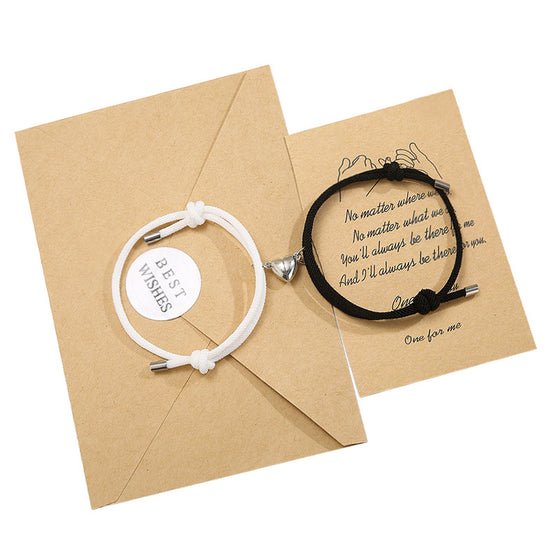 White and black couple bracelets with an envelope and card
