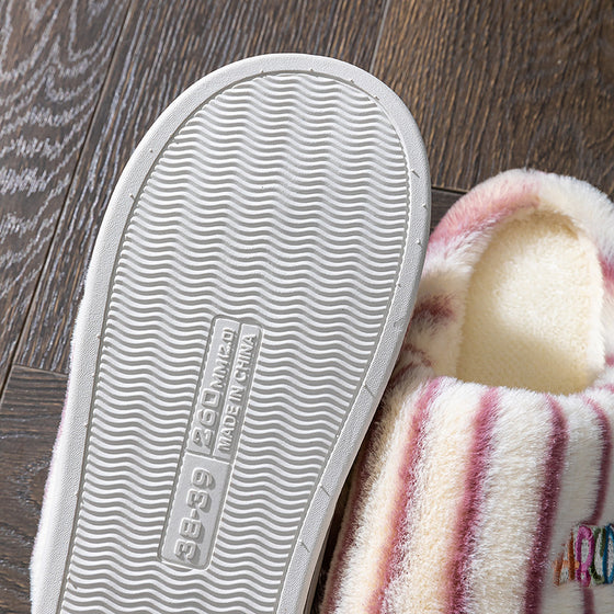 Wave tread sole of a striped plush slipper, close-up