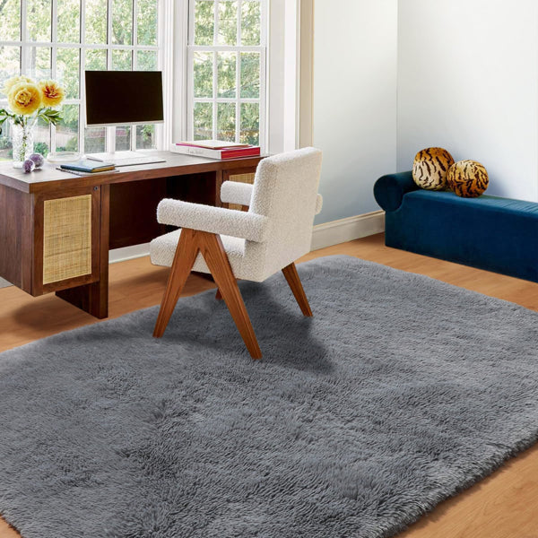 Grey shag rug placed under a bed