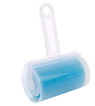 Lint roller and dust brush on clothing