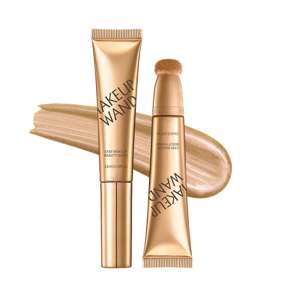 Gold makeup wand tube beside a smear of liquid product