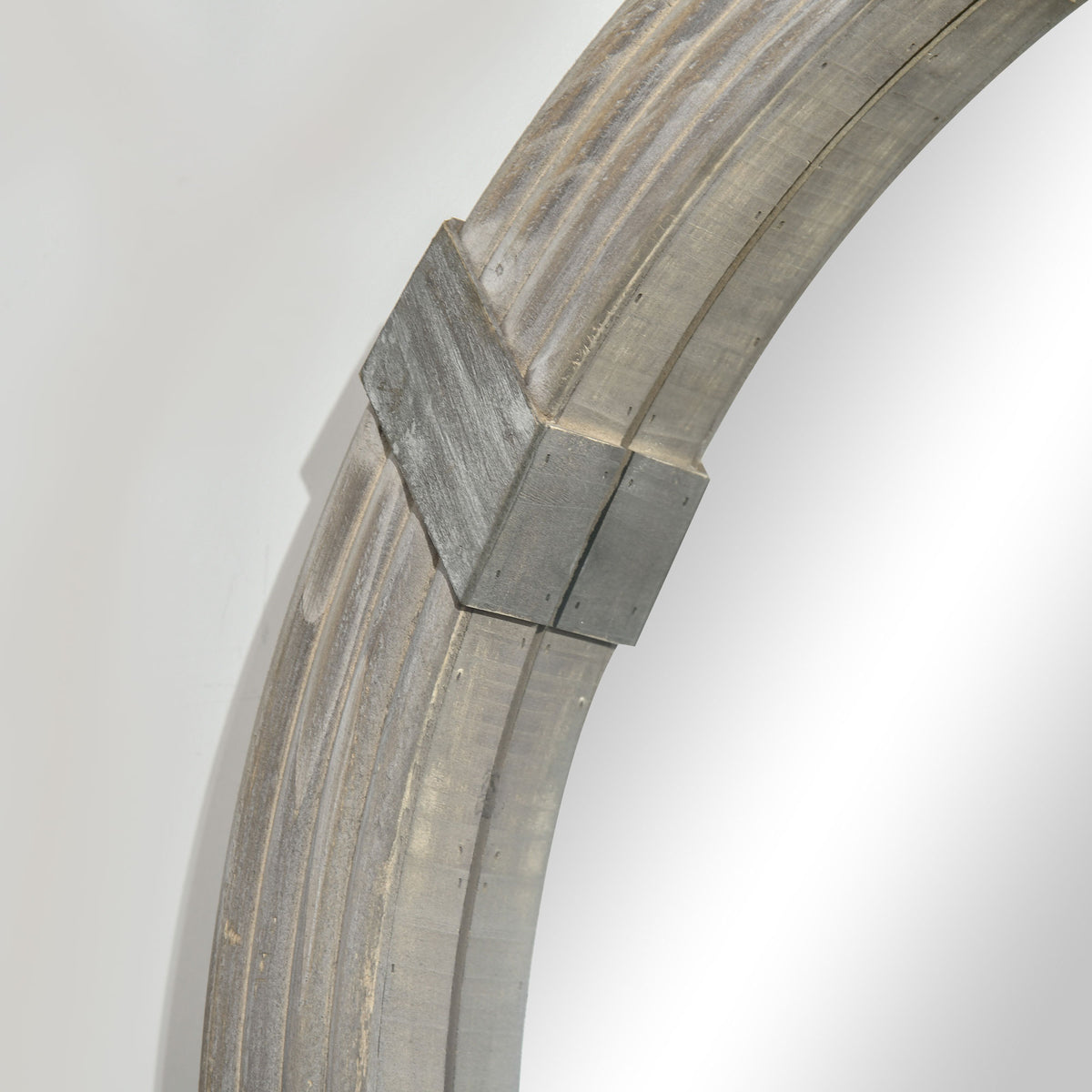 Angled view of round wood wall mirror