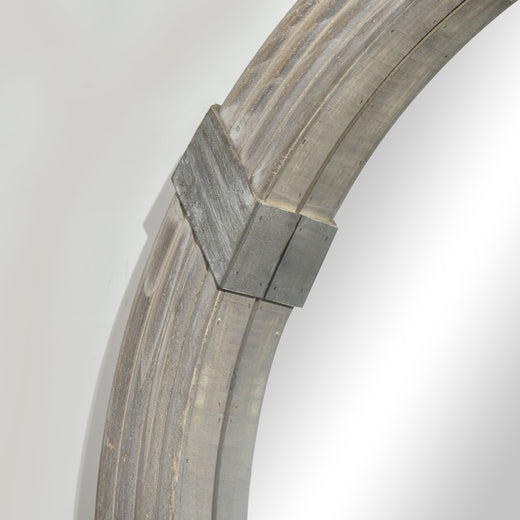 Angled view of round wood wall mirror