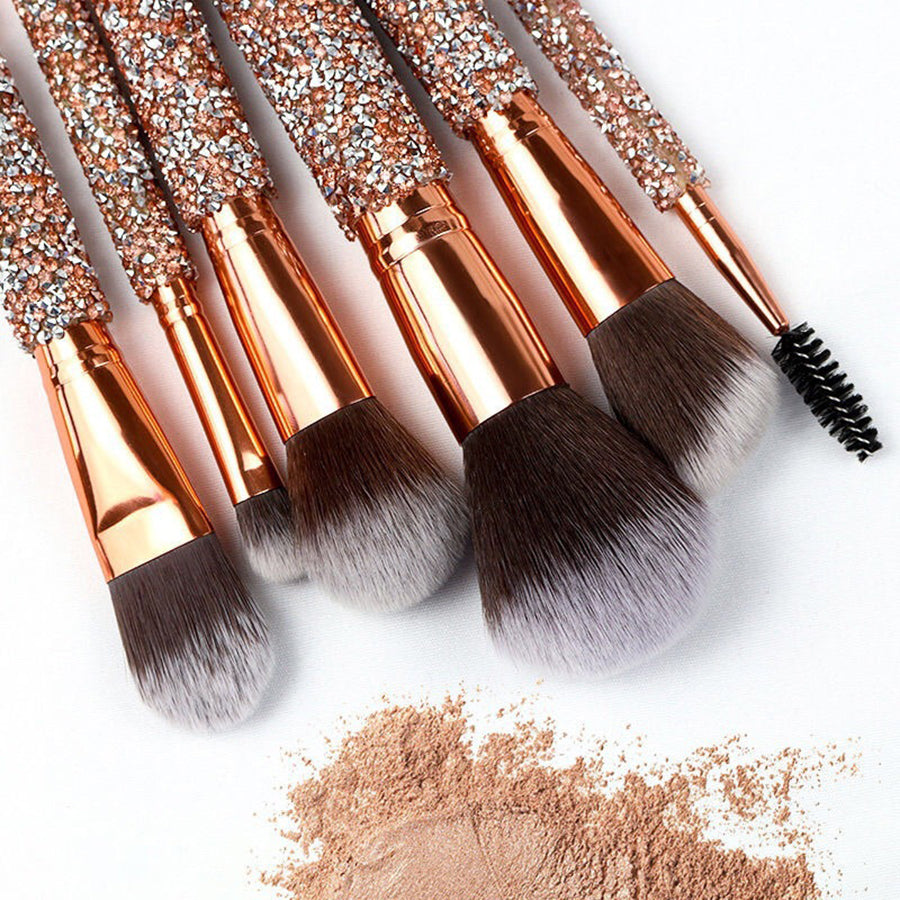 Close-up of sparkle makeup brushes over loose face powder