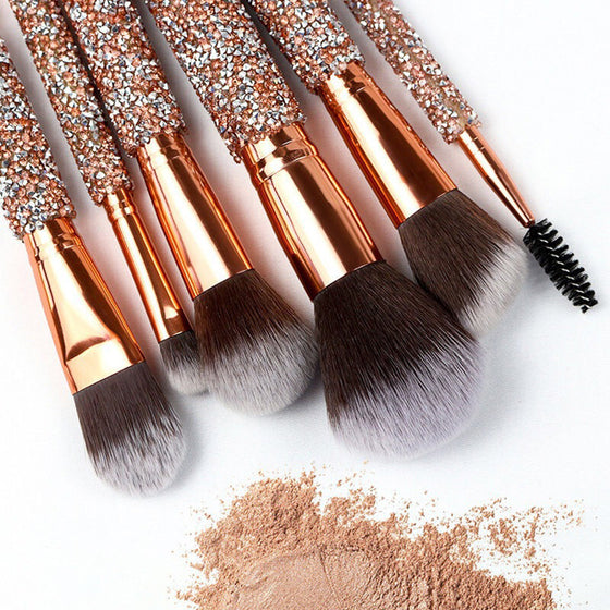 Close-up of sparkle makeup brushes over loose face powder