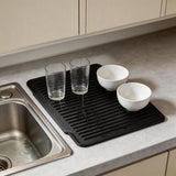 Silicone dish mat rolled up showing flexibility